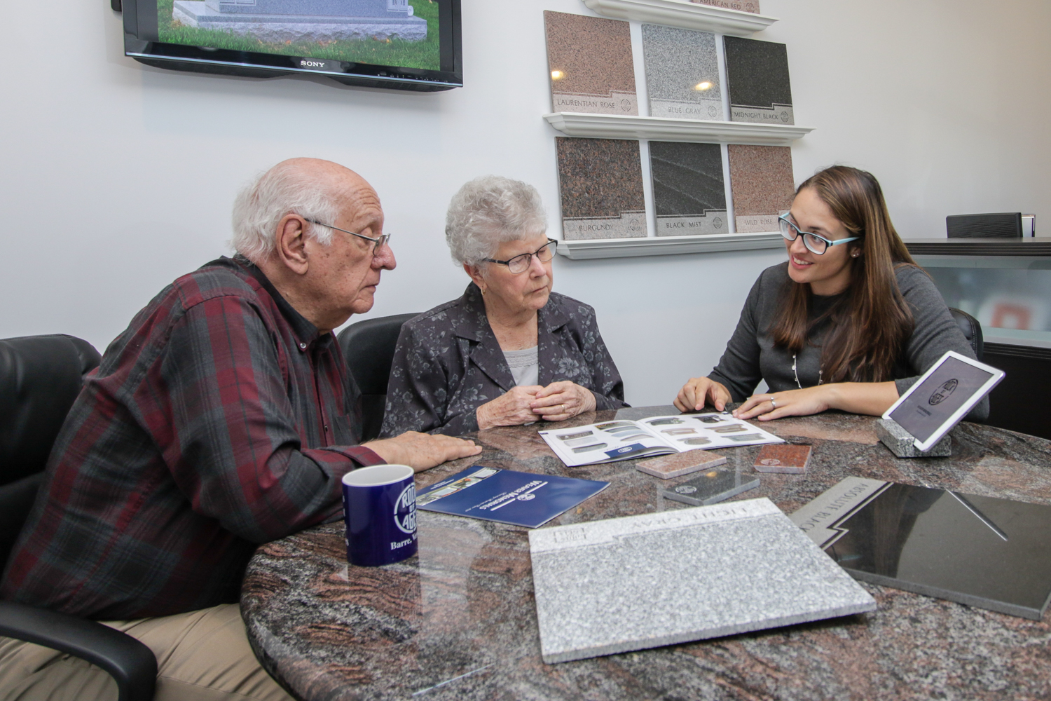 Elderly couple talking with Weaver Memorial rep about monument options