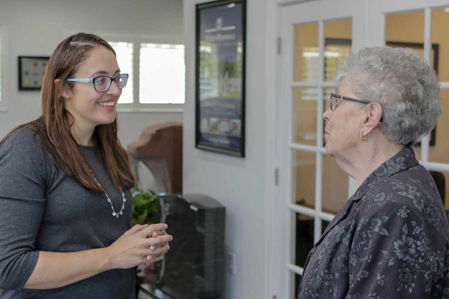 Elderly woman talking with younger woman