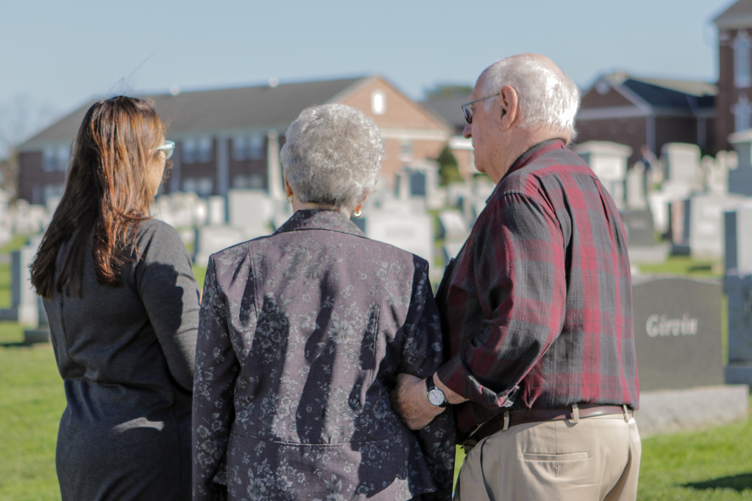 An elderly couple touring a grave installation site to visualize how different monuments would look when installed