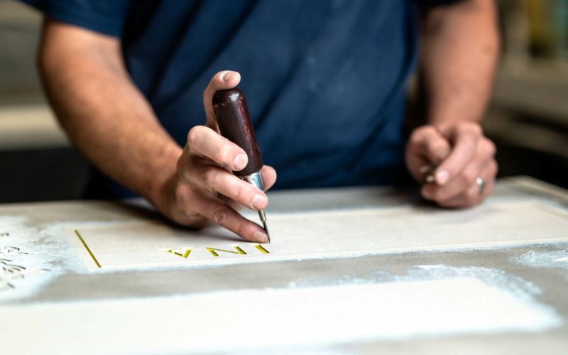 Engraving a granite slant headstone.