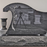 A black, granite headstone.