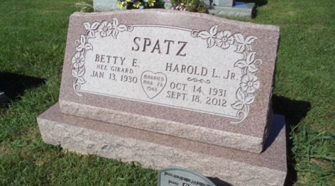 Custom red granite slanted memorial headstone.